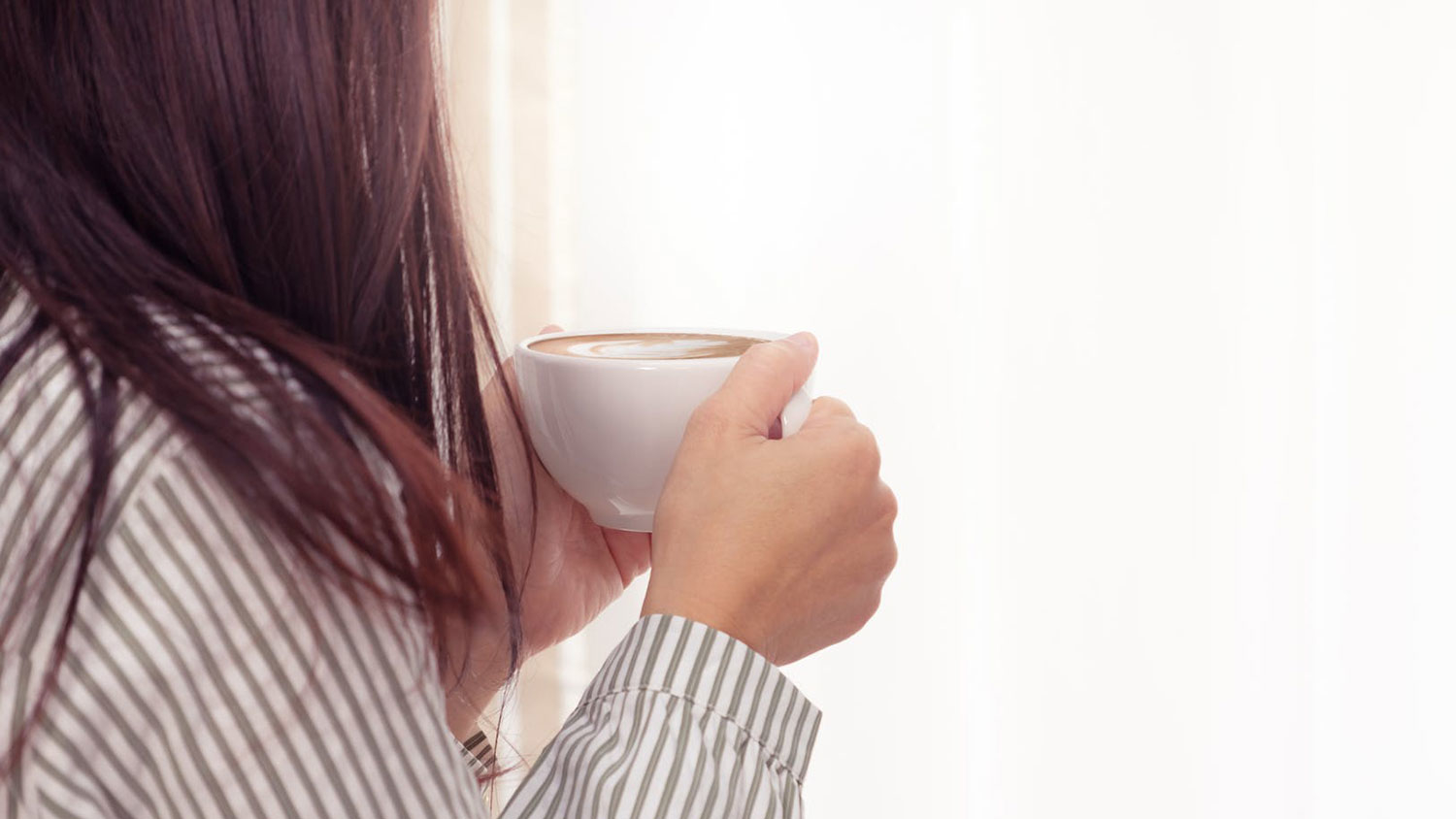 Woman holding coffee cup